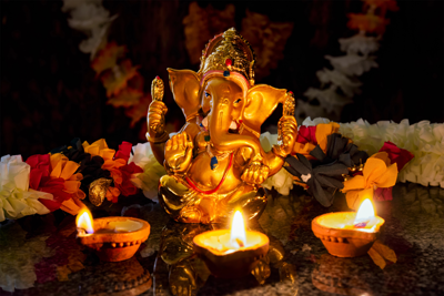 Golden Ganesha statue surrounded by glowing diyas during Diwali – symbol of wisdom and renewal.